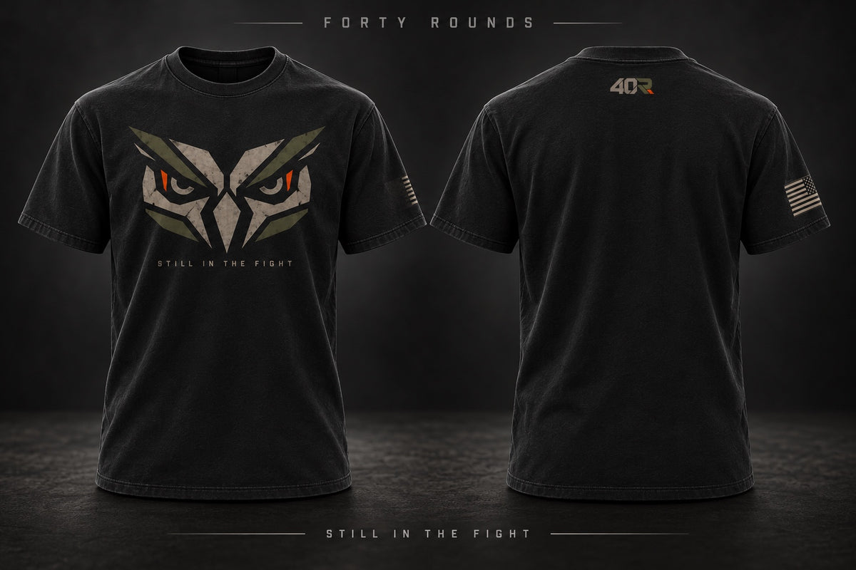 Black tee concept with angular owl artwork and Still in the Fight lettering, front and back.